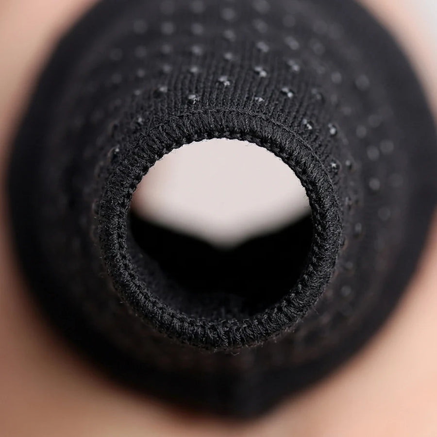Macro of the glove's open fingertip edge showing the compression knit's finished hem