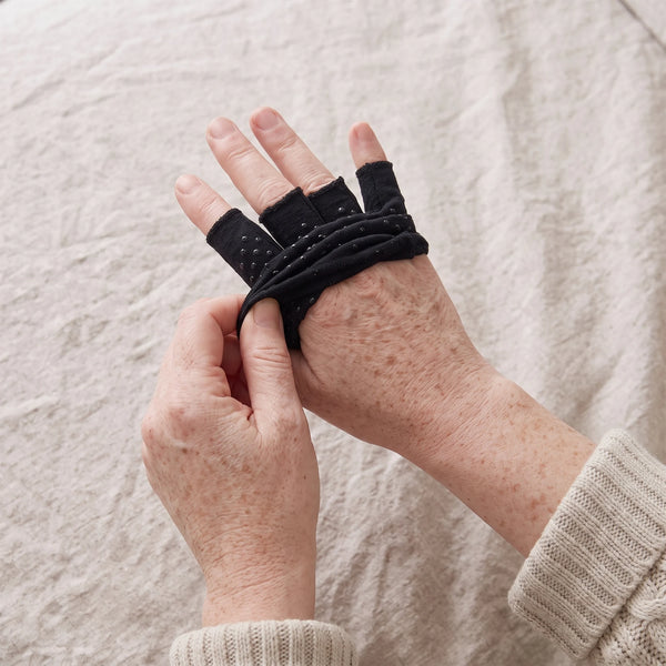 Hands removing the glove, laying it flat on linen to air dry