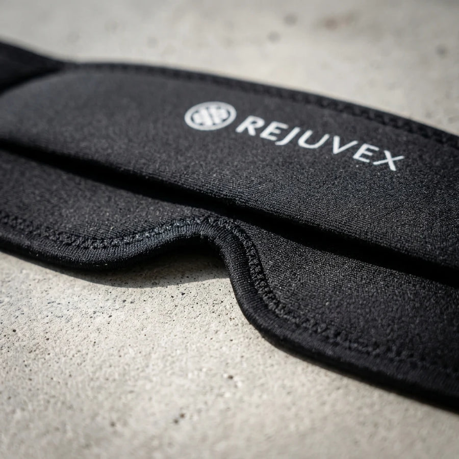 Macro view of the stitched fold where the blackout mask meets the migraine cap's stretch band