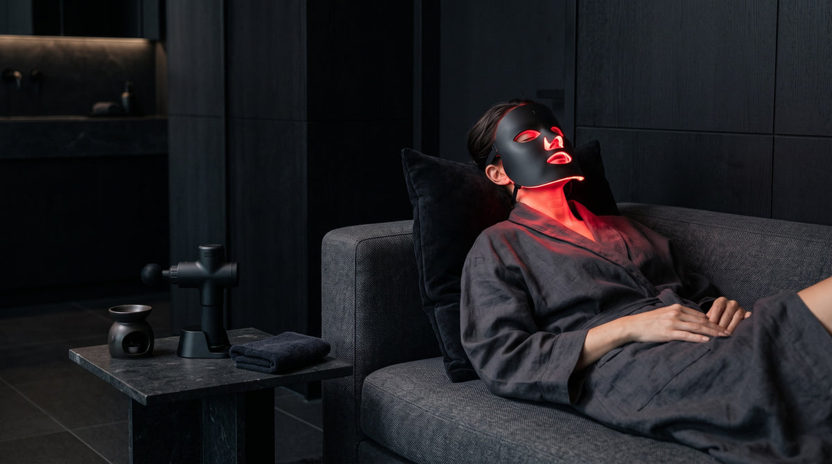 An evening red light therapy ritual in a warm porcelain living room